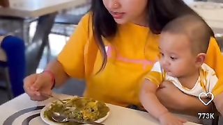 Mom enjoying her food with baby
