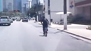 A young boy in Brazil practicing heading a ball while riding his bicycle????⚽