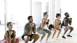 Woman learning to lift weights