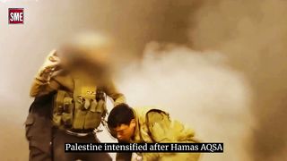 Confusing image! Did the Israeli soldier place a GPS device on a Hamas militant?