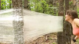 girl camping in the middle of the forest using plastic