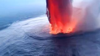 A volcanic eruption is appearing in the middle of the ocean