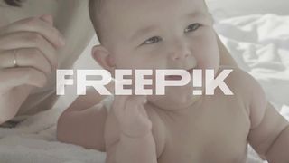 Portrait Of Cute Happy Baby Smiling With Mom In Bed