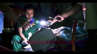 Surgery with phone light in Gaza