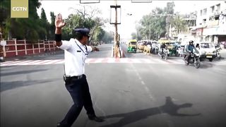 Who's bad? Indian traffic cop grabs motorists