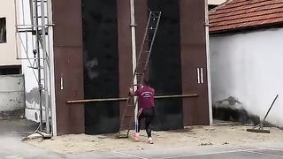 Man Deftly Ascends Building With Ladder __ ViralHog