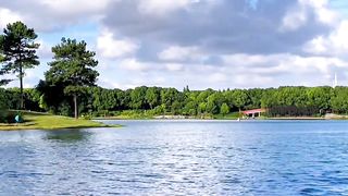 Green mountains, green water, blue sky and white clouds