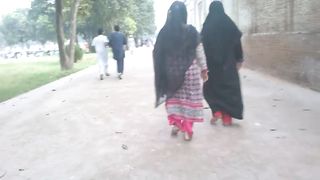 Girls walk in garden