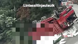 The seconds the truck overturned were seen in the background