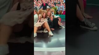 The girl sits tightly so as not to fall off the Devil's wheel