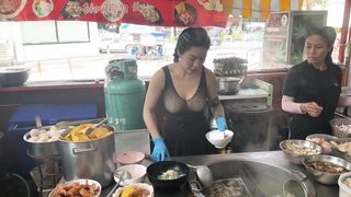 Lady chef cooking the most popular pork noodles - Thai street food
