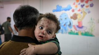 Gaza emergency worker breaks down in tears while cradling baby