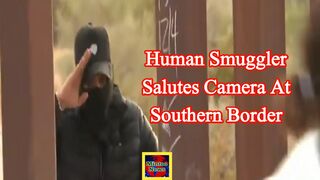 Human smuggler salutes camera at southern border