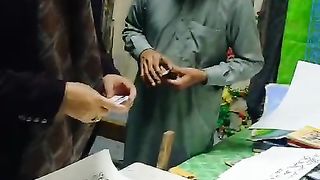 Former MPA Sheikh Ijaz Ahmed is looking at the handwritten verses of the Quran by a calligrapher