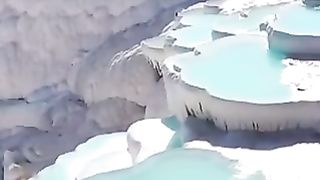 Pamukkale In Turkey,  known for its white terraces of travertine, formed by mineral-rich  springs.