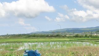Watching the plane land from the hut in the rice fields