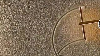 Menggambar di atas pasir