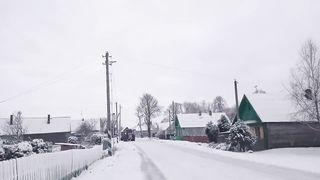 The tractor drove along the winter road
