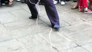 an old man does a trick with a spinner