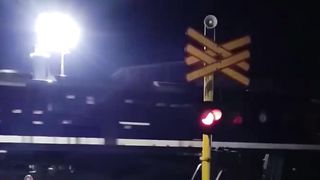 Nighttime Journey: The Graceful Dance of a Train in Darkness