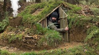 Building complete and warm survival shelter Bushcraft earth hut,grass roof & fireplace with clay