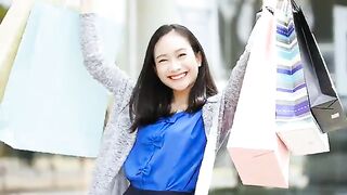 The Girl Happily Smile Happily In The Stop. She Turned And Showed A Paper Bag.
