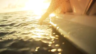 Hand Brushes Water Off Side Of Boat