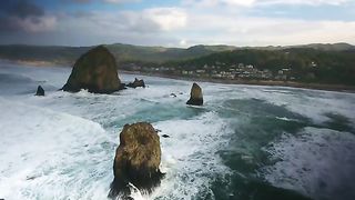 Drone Footage Over Beach With Large Rocks In The Water