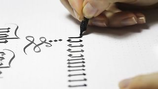 Woman Writes Calligraphic Letters