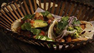 Rotating Shot Of Delicious Tacos On A Wooden Surface