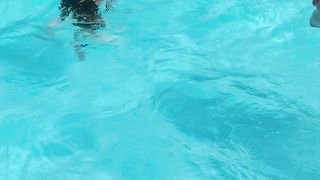 Cute child swimming in swimming pool.