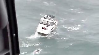 USCG rescue swimmer conducting a rescue in what appears to be moderate waves nothing too extreme But then chaos ensues