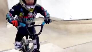 5 year old riding a BMX over ramps way above his height ????