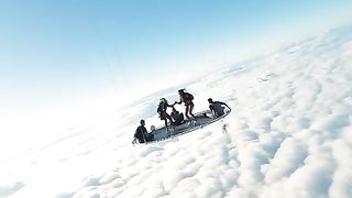 Extreme athletes have installed a trampoline on a  air balloon