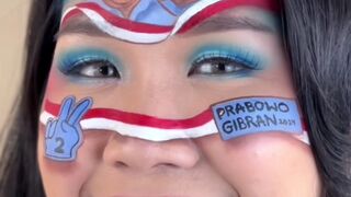 Viral Seorang Perempuan Melukis Wajahnya dengan gambar Capres Cawapres.