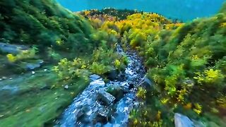 The lake at the end -- It was just getting dark when I discovered this waterfall over the autumn trees in Switzerland --