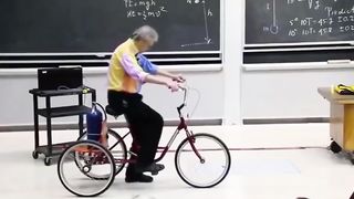 Watch Walter Lewin showcasing Newton's third law of motion in a University class
