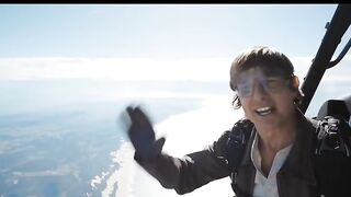 "HELI" IS COOL: Tom Cruise thanks fans for "Top Gun's" success as he leaps from a helicopter.