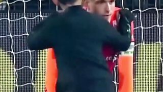 Little boy runs onto the pitch and hugs goalkeeper who lost in the last minute.