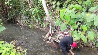 the boy hunting and fishing in the river denpasar bali indonesia
