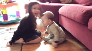 Precious moment between sister and baby brother