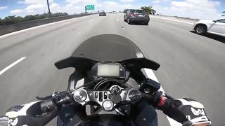 Police officer purposely slams on brakes to get biker to crash into him on the highway.