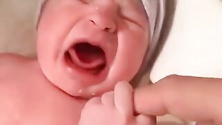 Newborn baby hold hand's mom!