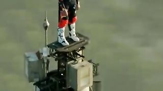 Sam Sunderland standing on top of the Burj Khalifa, Dubai.
