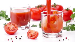 Pouring tomato juice into a glass