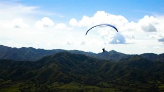 Skydiver flying over a mountain range