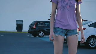 Girl gently skating in a parking lot