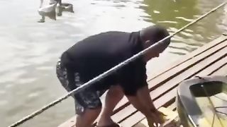 The fisherman is trying to cope with his catch