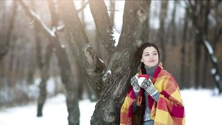 Woman enjoying a  drink in the winter forest