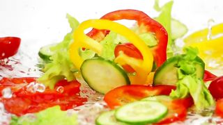 Slices of vegetables falling into the water